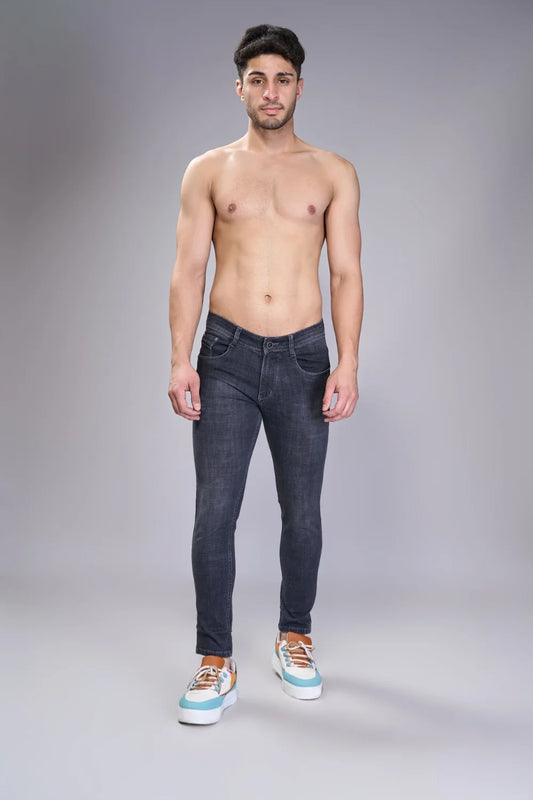 Slim tapered denim in dark grey emphasizing cropped ankle profile