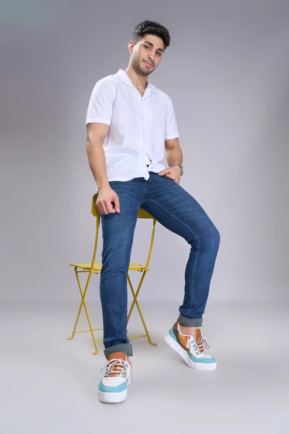 Model wearing men’s light blue regular fit jeans styled casually