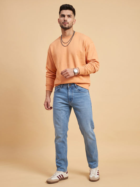 Man wearing light blue straight fit jeans, full standing view