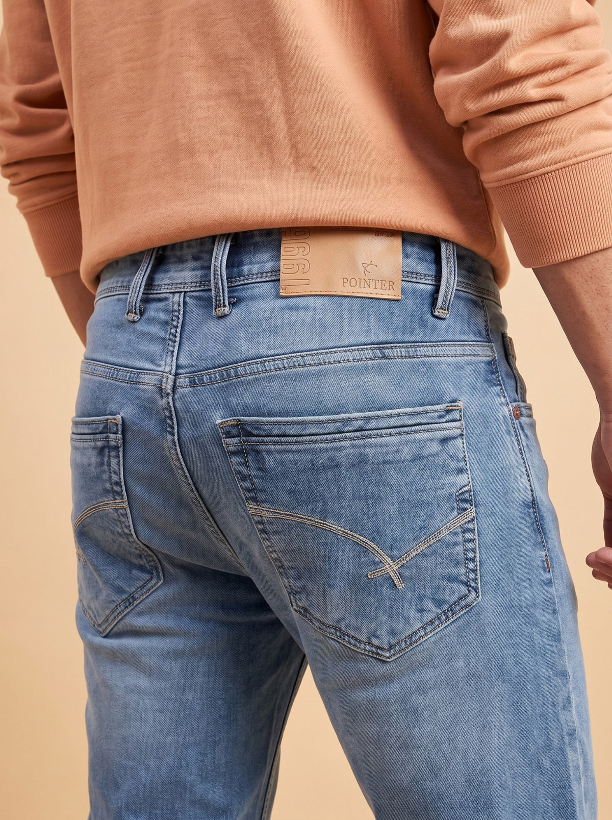 Light blue jeans rear pocket and branded waistband detail