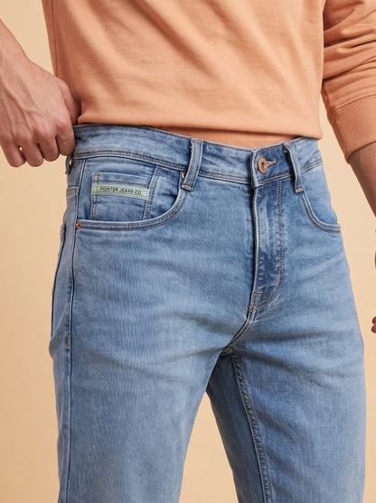 Light blue jeans waistband and front pocket close-up