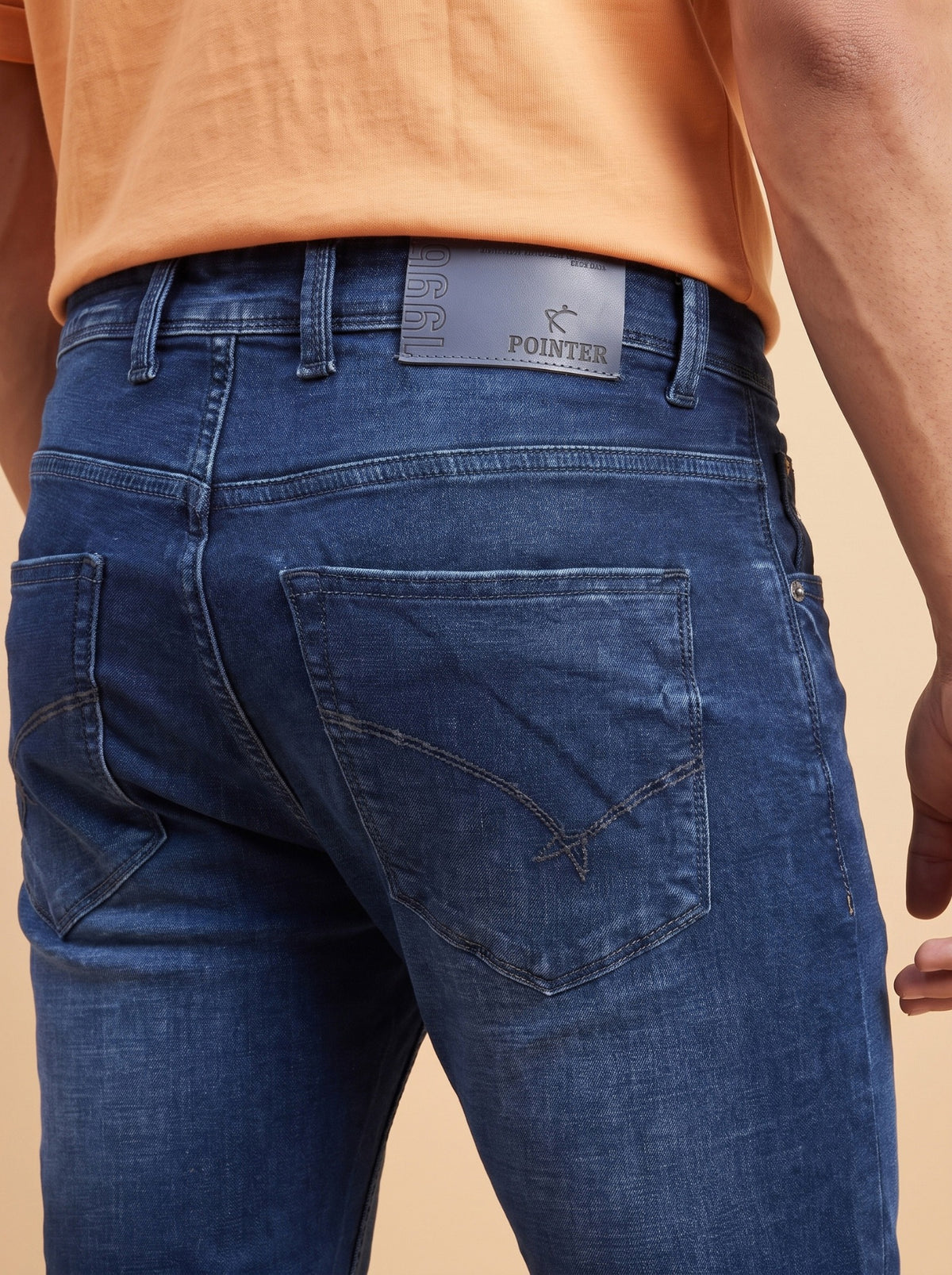 Dark indigo jeans rear pocket and waistband detail