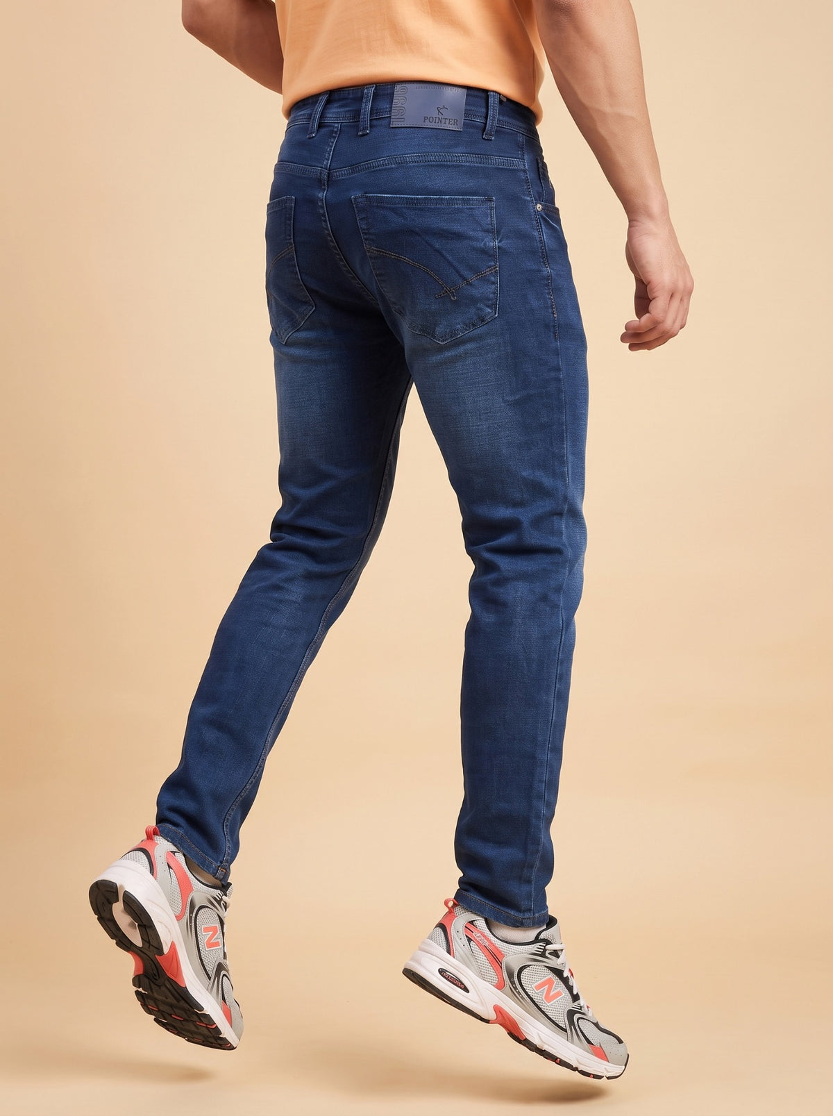 Men wearing dark indigo slim fit jeans from the back