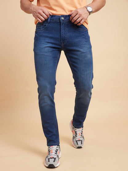 Men's dark indigo jeans walking front view