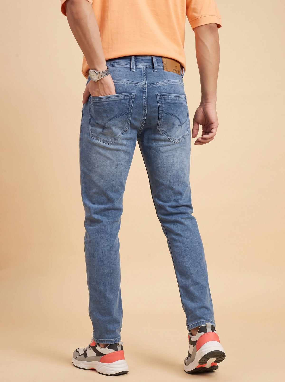 Men's mid-blue slim fit jeans back view