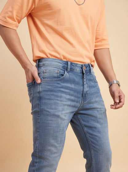 Mid-blue jeans front pocket and wash close-up
