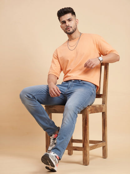 Men's mid-blue stretch jeans seated comfort view
