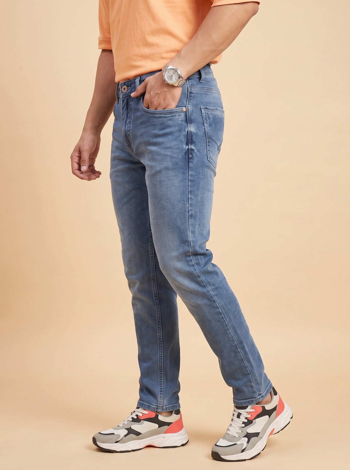 Men's mid-blue slim fit jeans side view
