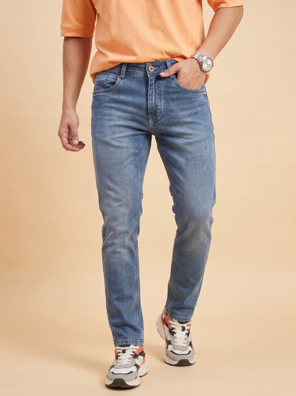 Men wearing mid-blue slim fit jeans while walking