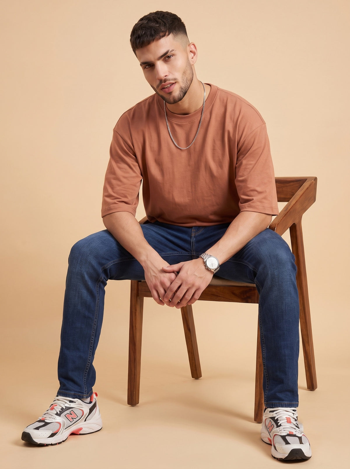 Men's deep blue slim fit jeans seated front view
