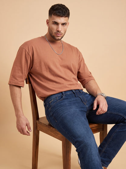 Men's deep blue stretch jeans seated angle
