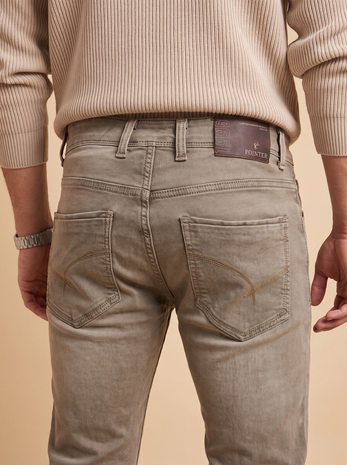 Taupe grey jeans rear pockets and waistband detail