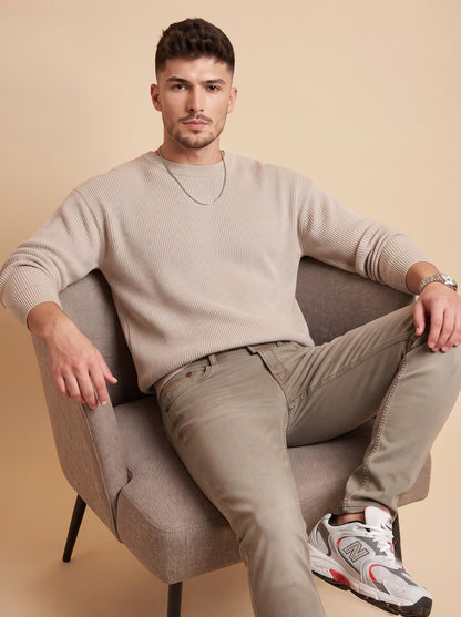 Men's taupe stretch jeans seated angle