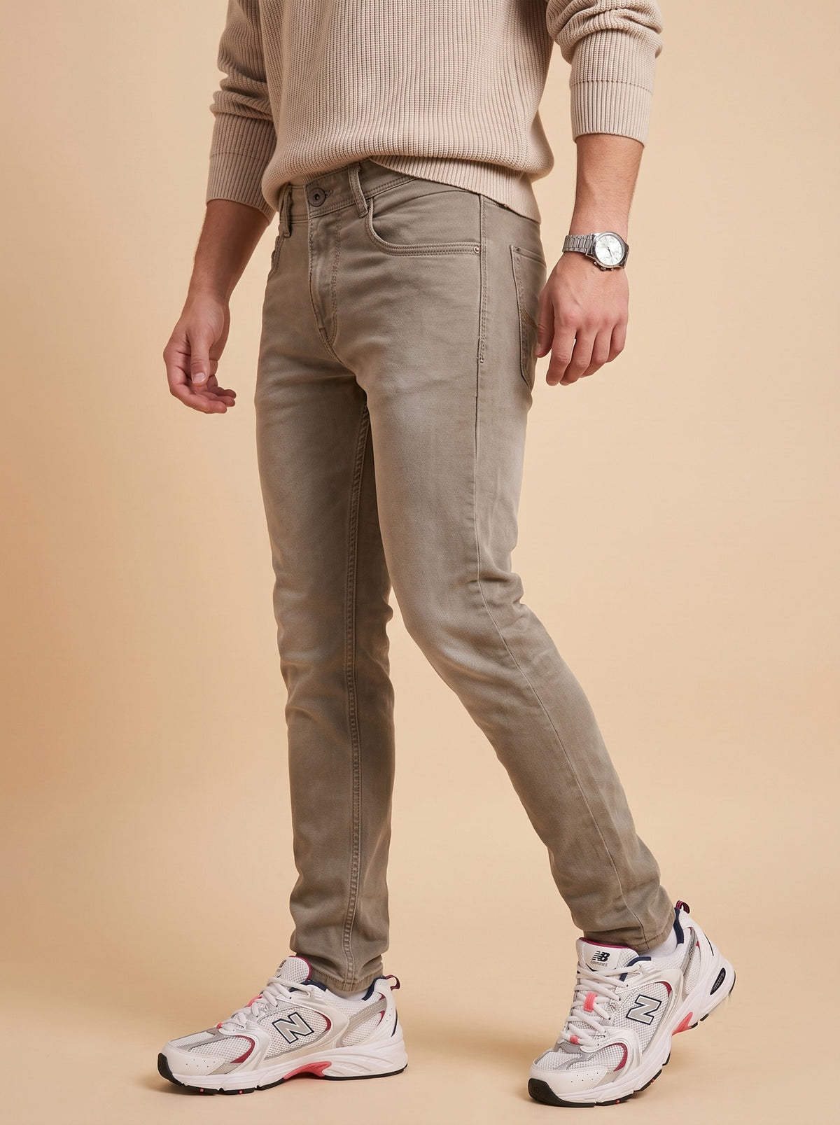 Men wearing taupe grey slim fit jeans while walking
