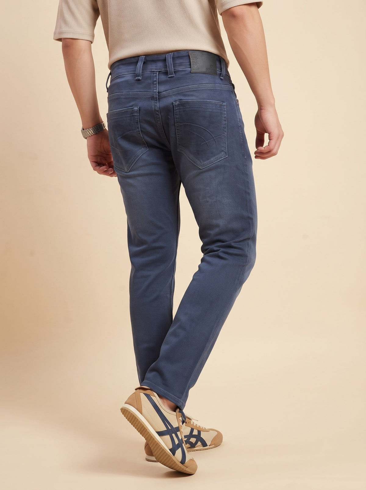 Men's steel blue slim fit jeans rear walking view