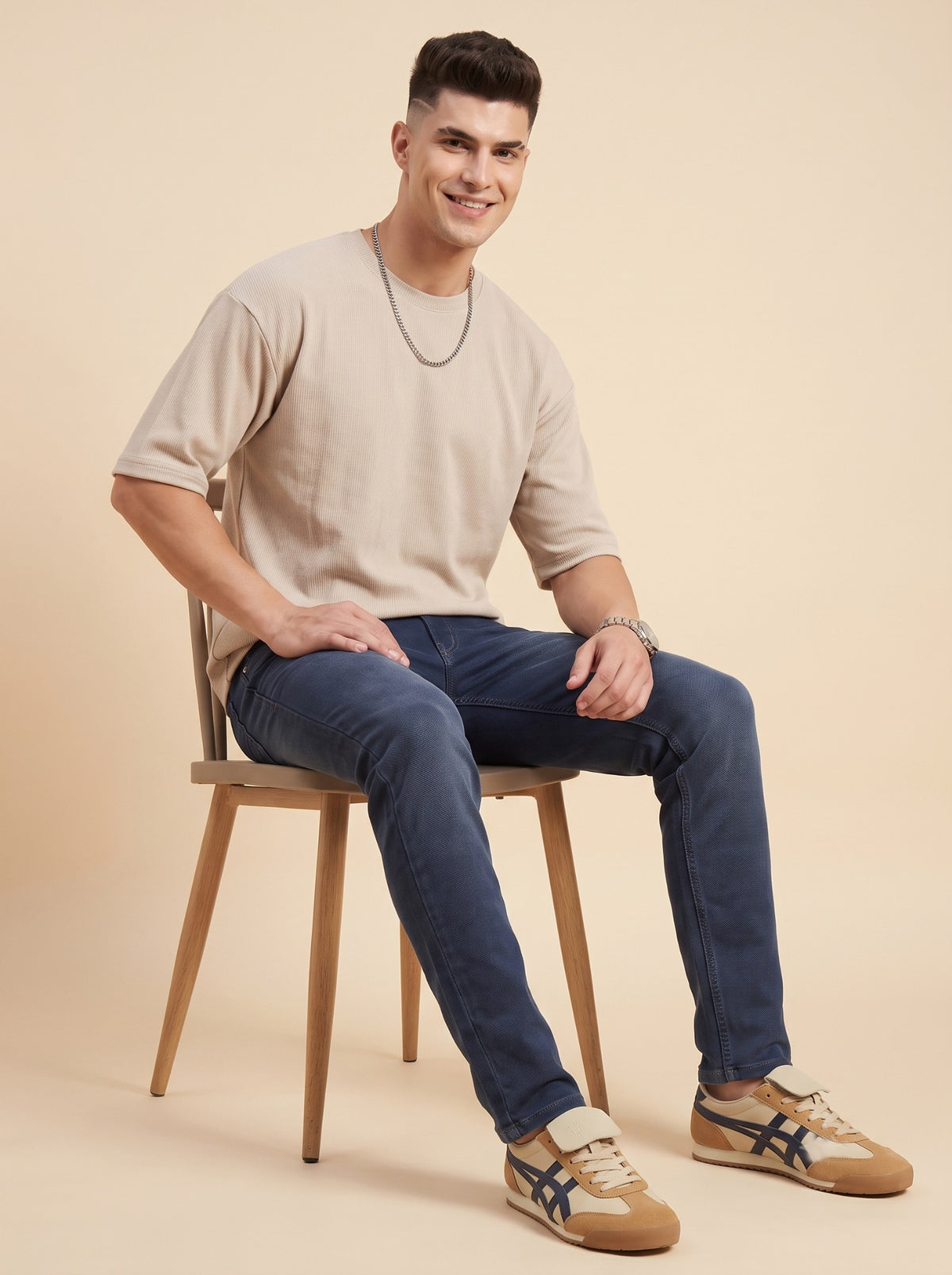 Men's steel blue stretch jeans seated front