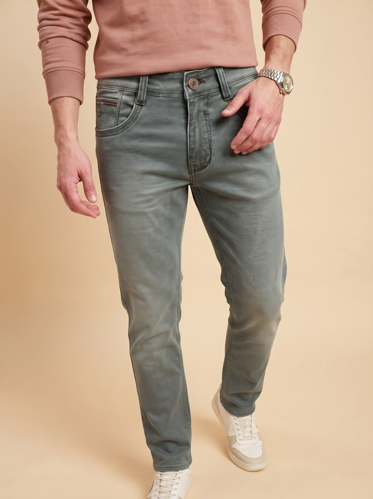 Men wearing sage grey slim fit jeans while walking