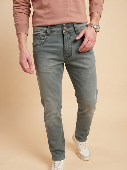 Men wearing sage grey slim fit jeans while walking