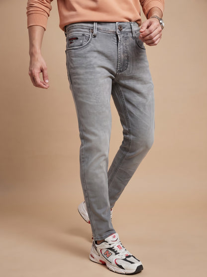 Men wearing light grey slim fit jeans while walking