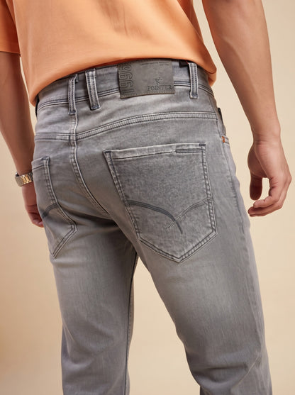 Ash grey denim jeans showing back pocket stitching and waistband detail