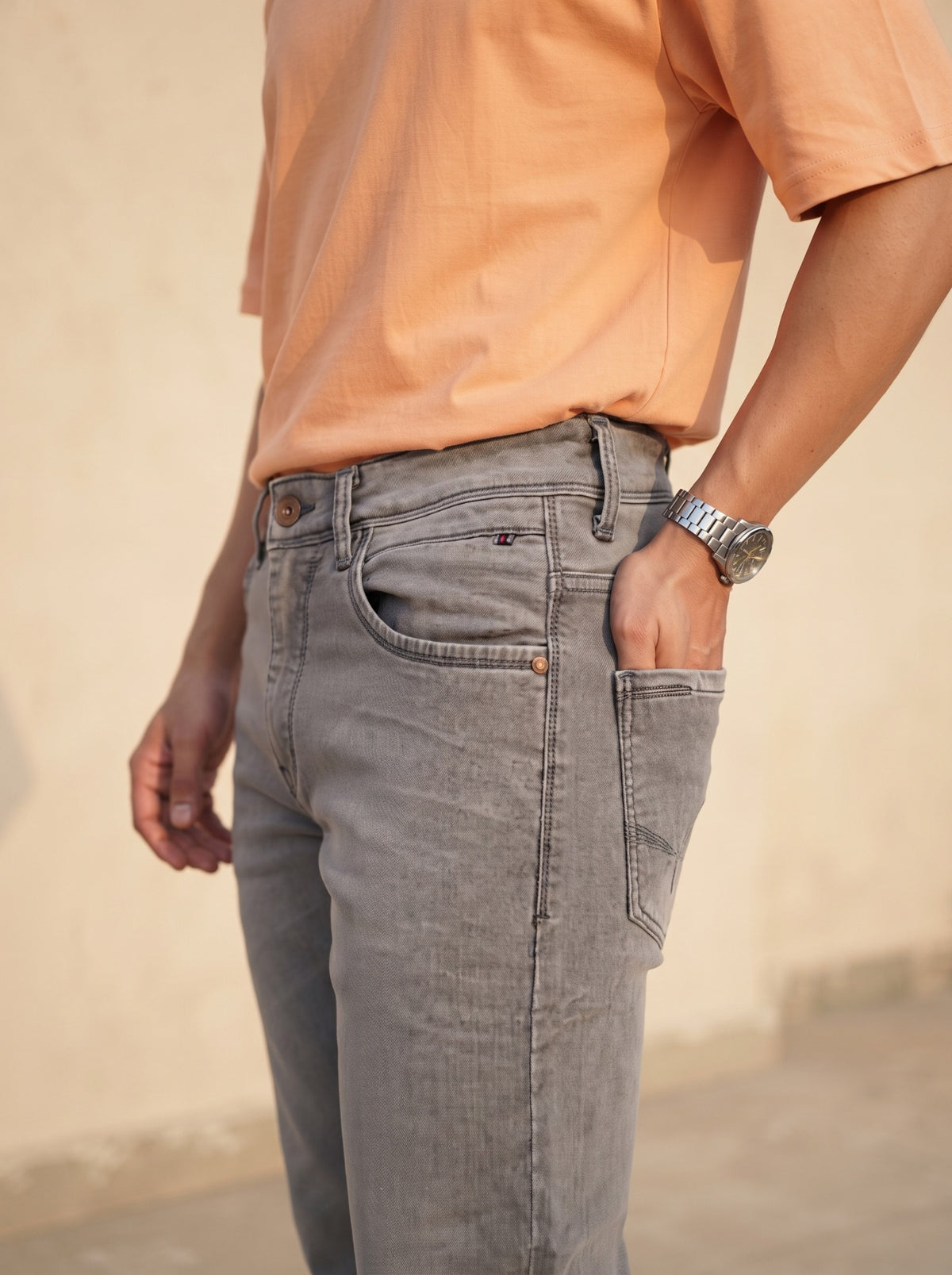 Men's ash grey jeans showing side profile and five-pocket construction