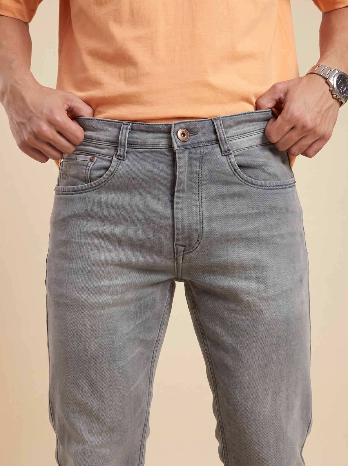 Ash grey straight fit jeans showing waistband, button and front pockets