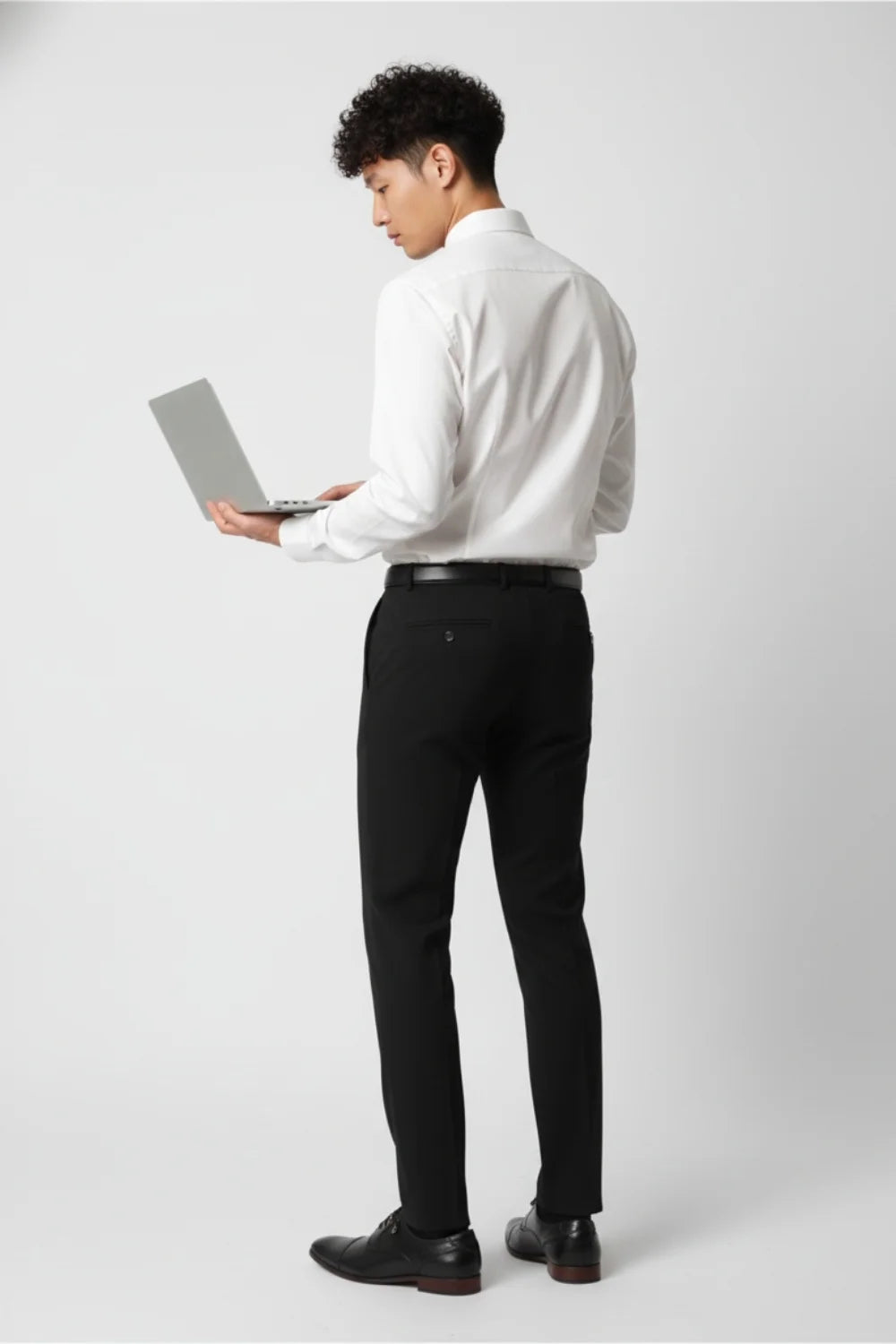 Hem and pocket detail on modern black formal trousers
