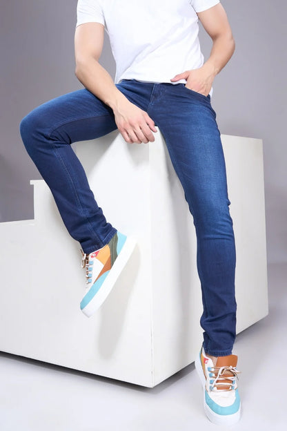 Model styling blue regular fit jeans for men in casual everyday outfit.
