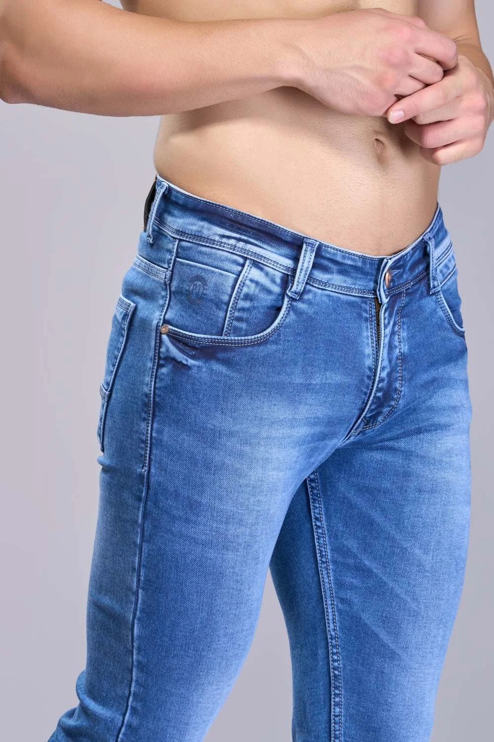 Lifestyle shot featuring blue tapered denim in a relaxed setting
