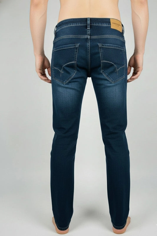 Close-up shot of the premium stitching and deep blue denim weave of the slim fit jeans.