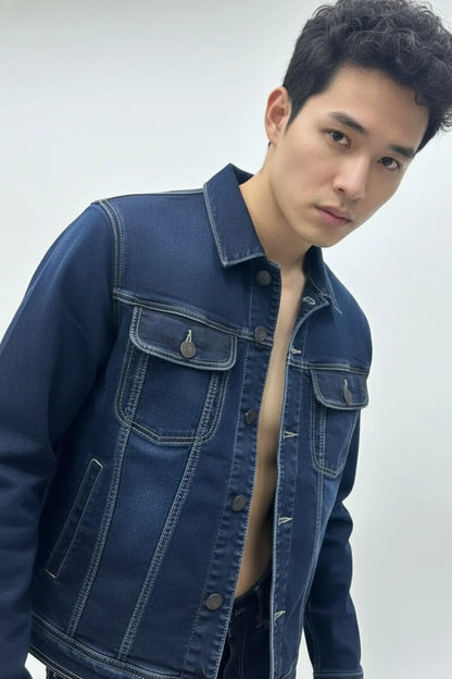 Close-up view showing stitching and buttons on dark blue denim jacket
