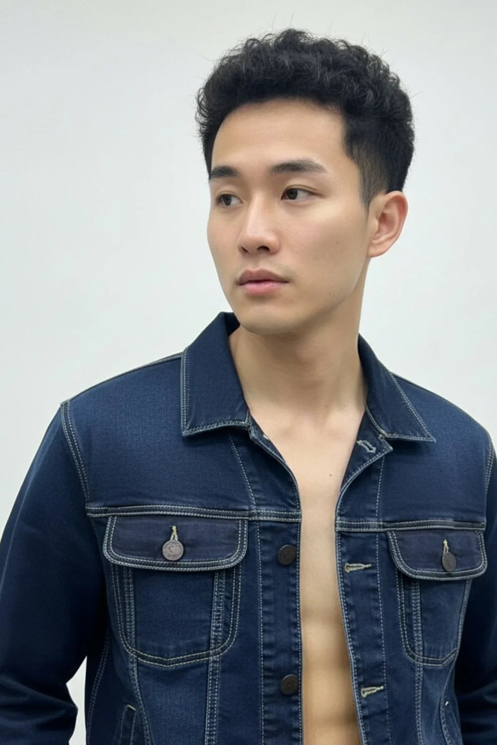 Dark blue denim jacket layered over a hoodie