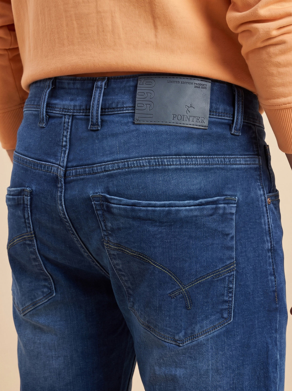 Deep indigo denim jeans showing back pockets and Pointer waistband patch
