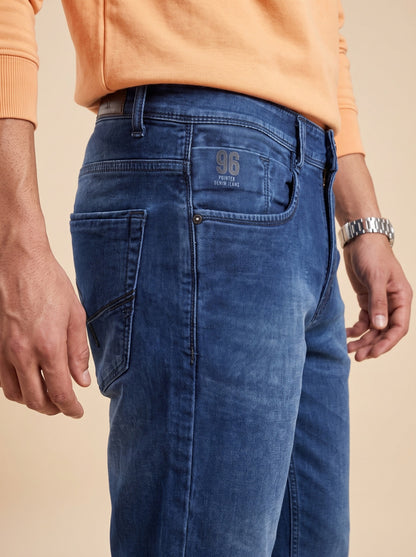 Deep indigo straight fit jeans showing coin pocket and denim texture