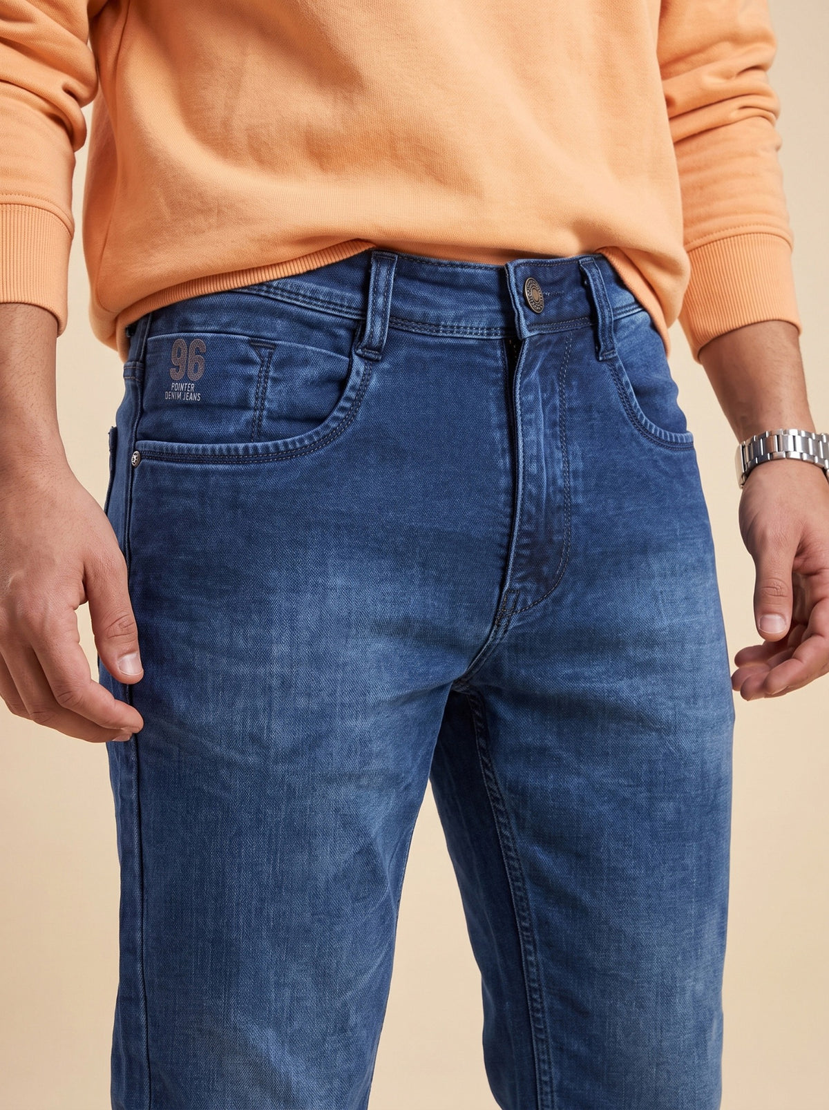 Deep indigo straight fit jeans showing waistband and front pockets