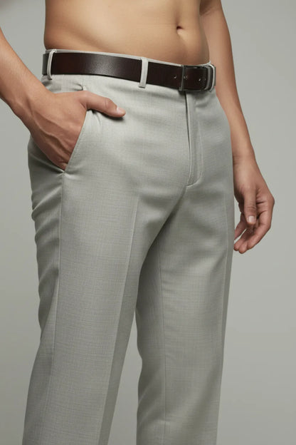 Light gray white pants with a brown belt on a plain background
