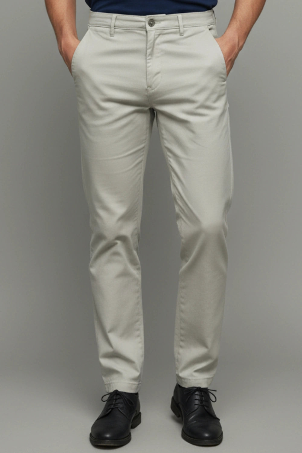 A complete front view showing the clean, slim-tapered silhouette of the trousers