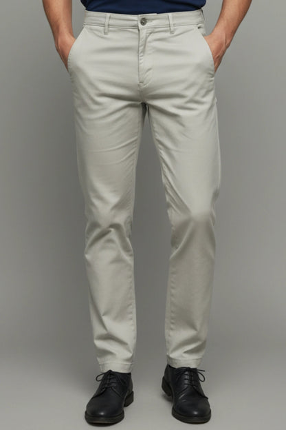 A complete front view showing the clean, slim-tapered silhouette of the trousers