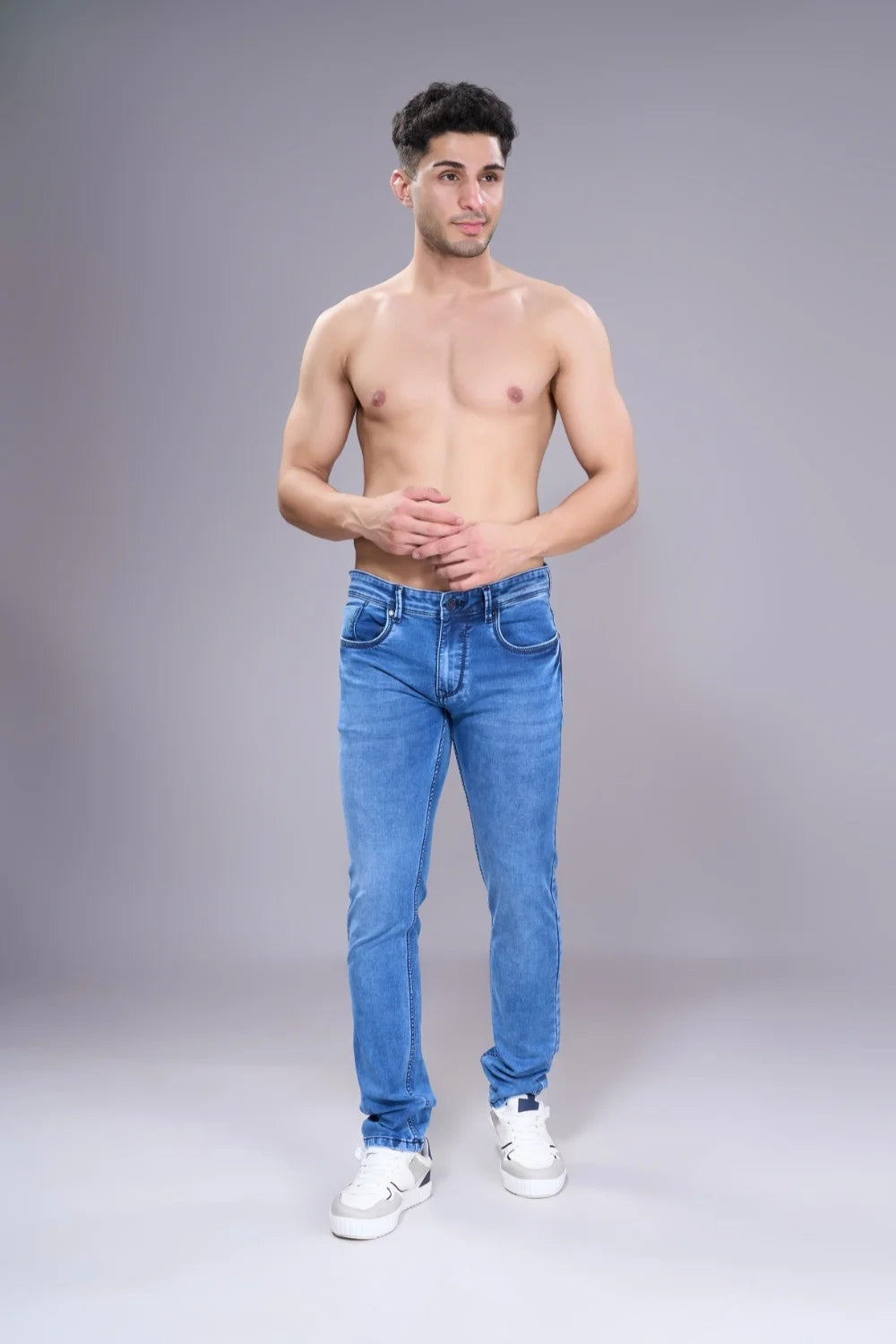 Model showcasing ice blue regular fit jeans in a clean front look

