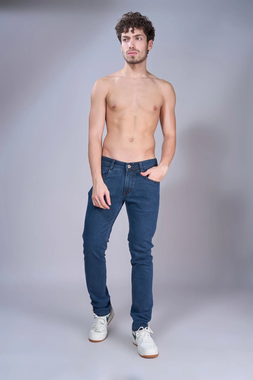 Male model wearing indigo blue regular fit jeans full-length pose
