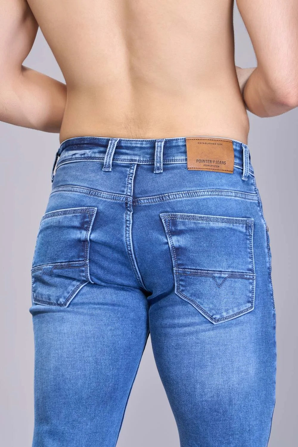 Tonal stitching details on structured blue jeans
