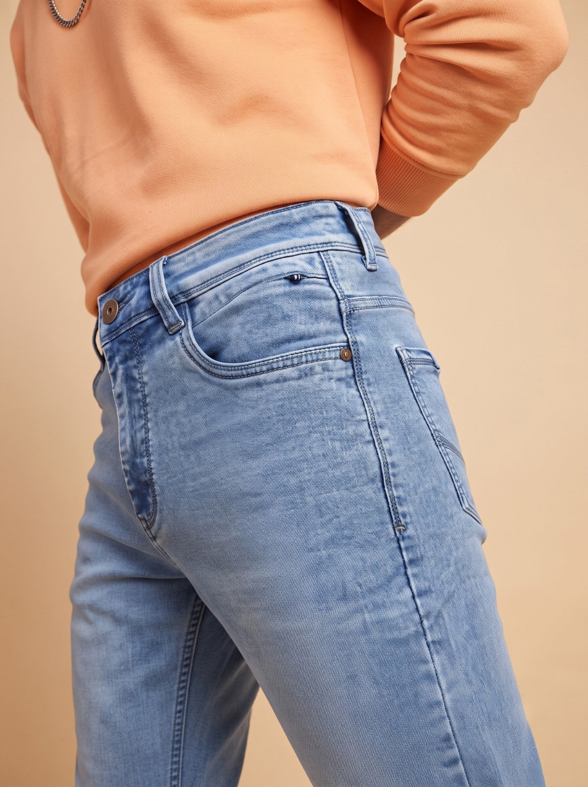 Men's light blue jeans showing side fit and front pocket construction