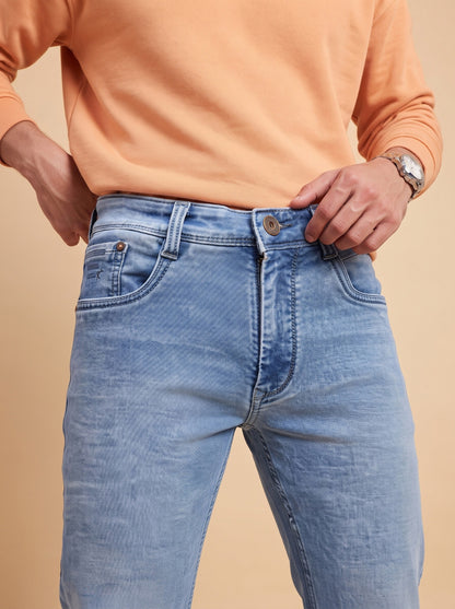 Light blue straight fit jeans showing waistband, button and front pockets