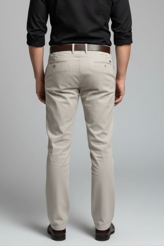 A model standing comfortably in light grey cotton pants