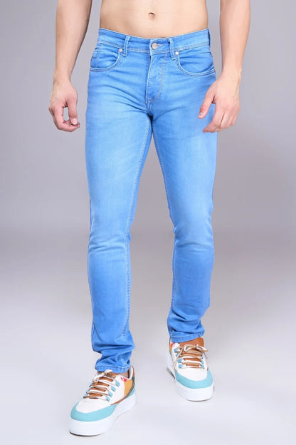 Man showcasing lightweight regular-fit light blue denim jeans in a studio pose
