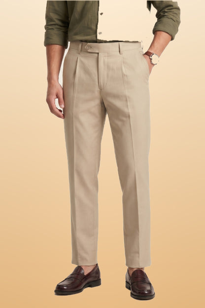 Men's cream slim fit formal pants on orange-beige studio background