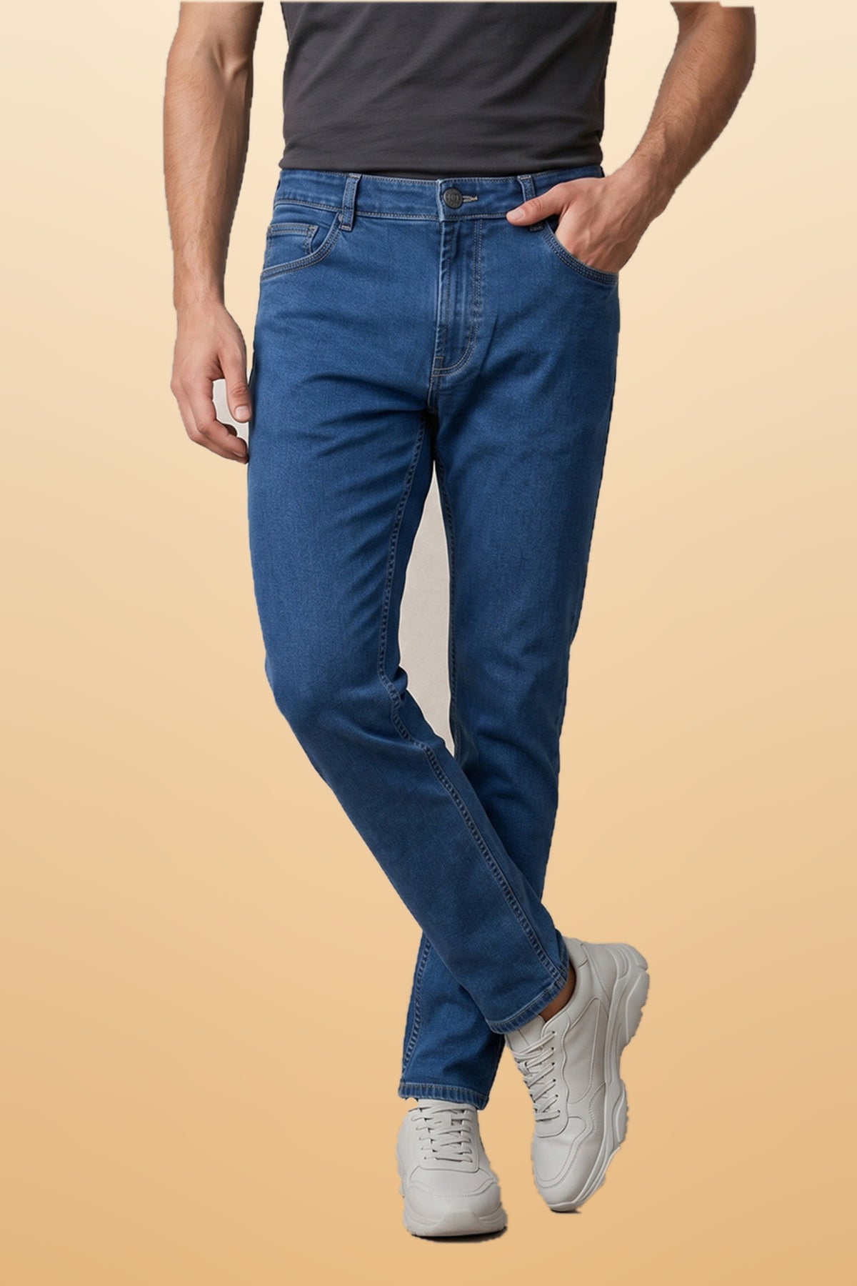 Men's light blue slim fit jeans on orange-beige studio background