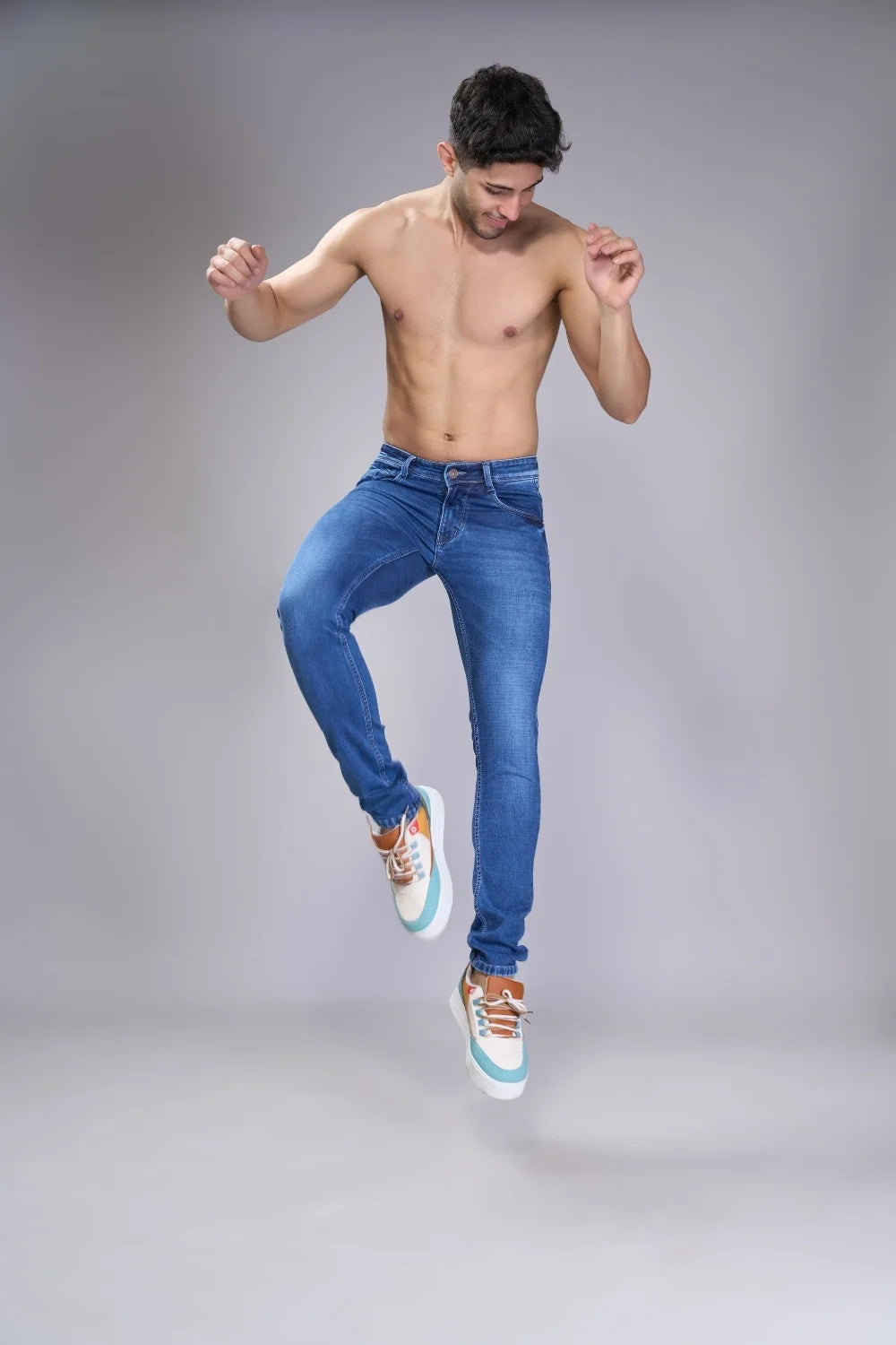 Lifestyle sitting pose of men wearing navy regular fit jeans
