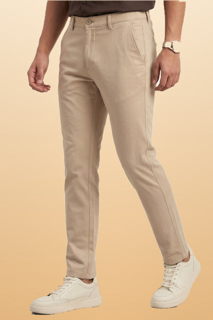 Men's beige cotton office pants on orange-beige studio background