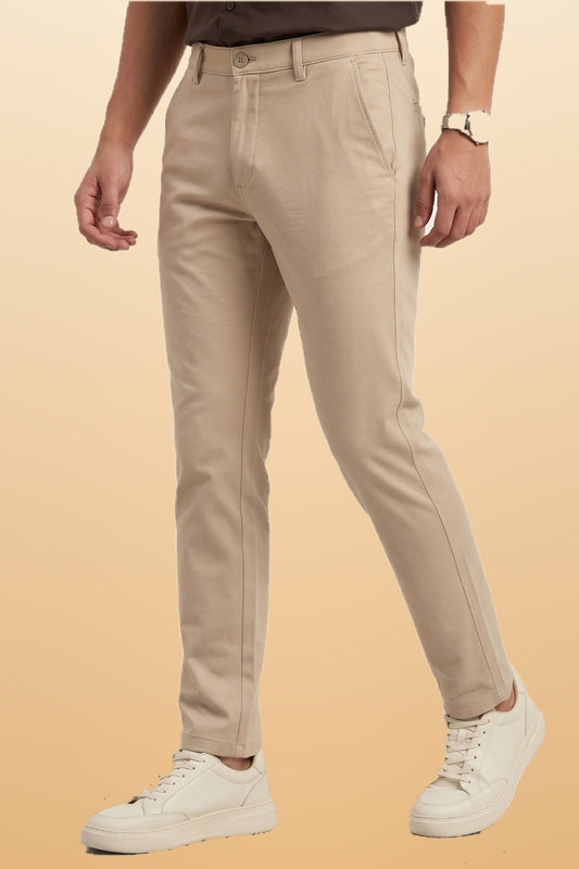 Men's beige cotton office pants on orange-beige studio background